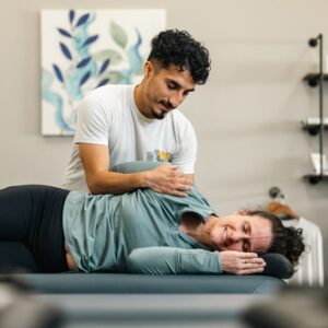 Client relaxing on the table during a one-on-one assisted stretch session